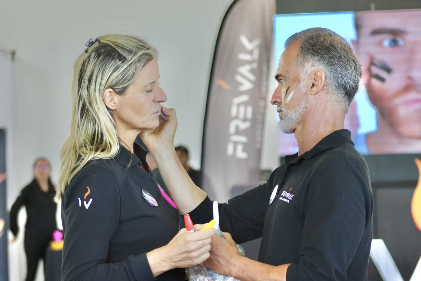 Estrella and Juan Carlos paint their faces before a dynamic